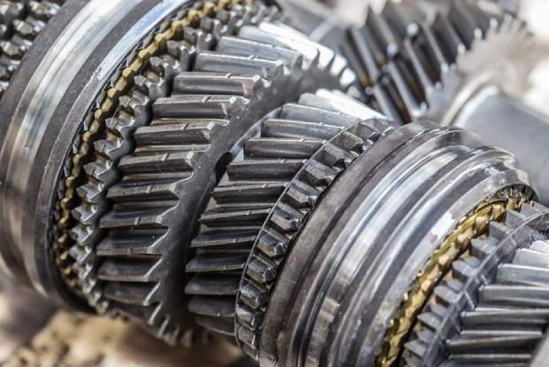 Close-up view of interlocking metal gears with detailed teeth, showcasing the intricate mechanical design and engineering of a gearbox or transmission system.